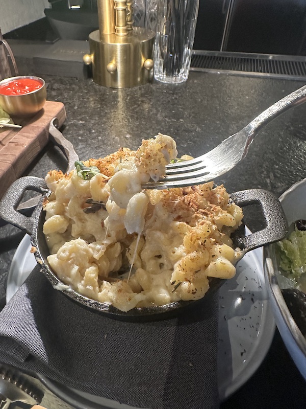 Wolf by Vanderpump mac and cheese in a black cast iron dish